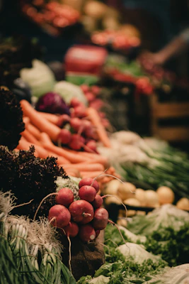 A display of exotic fruits and vegetables with rich textures and vibrant colors under natural light.