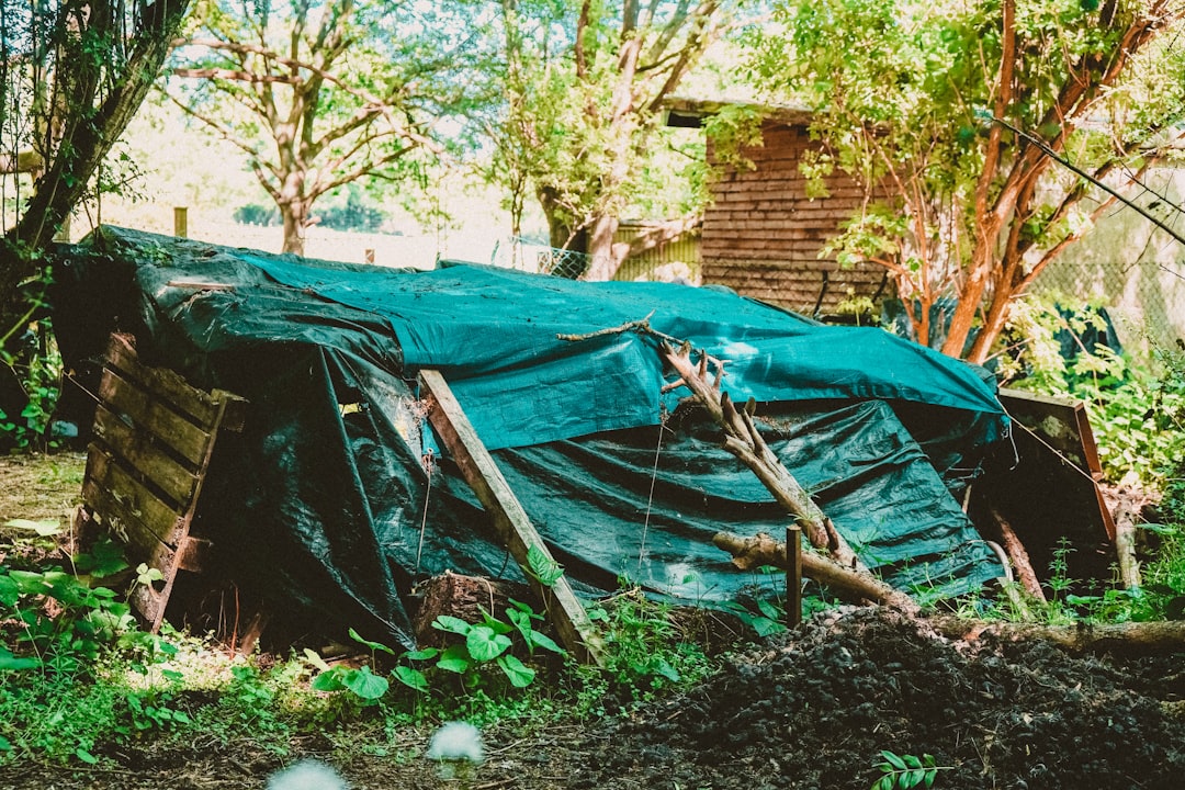 blue tent on brown wooden fence