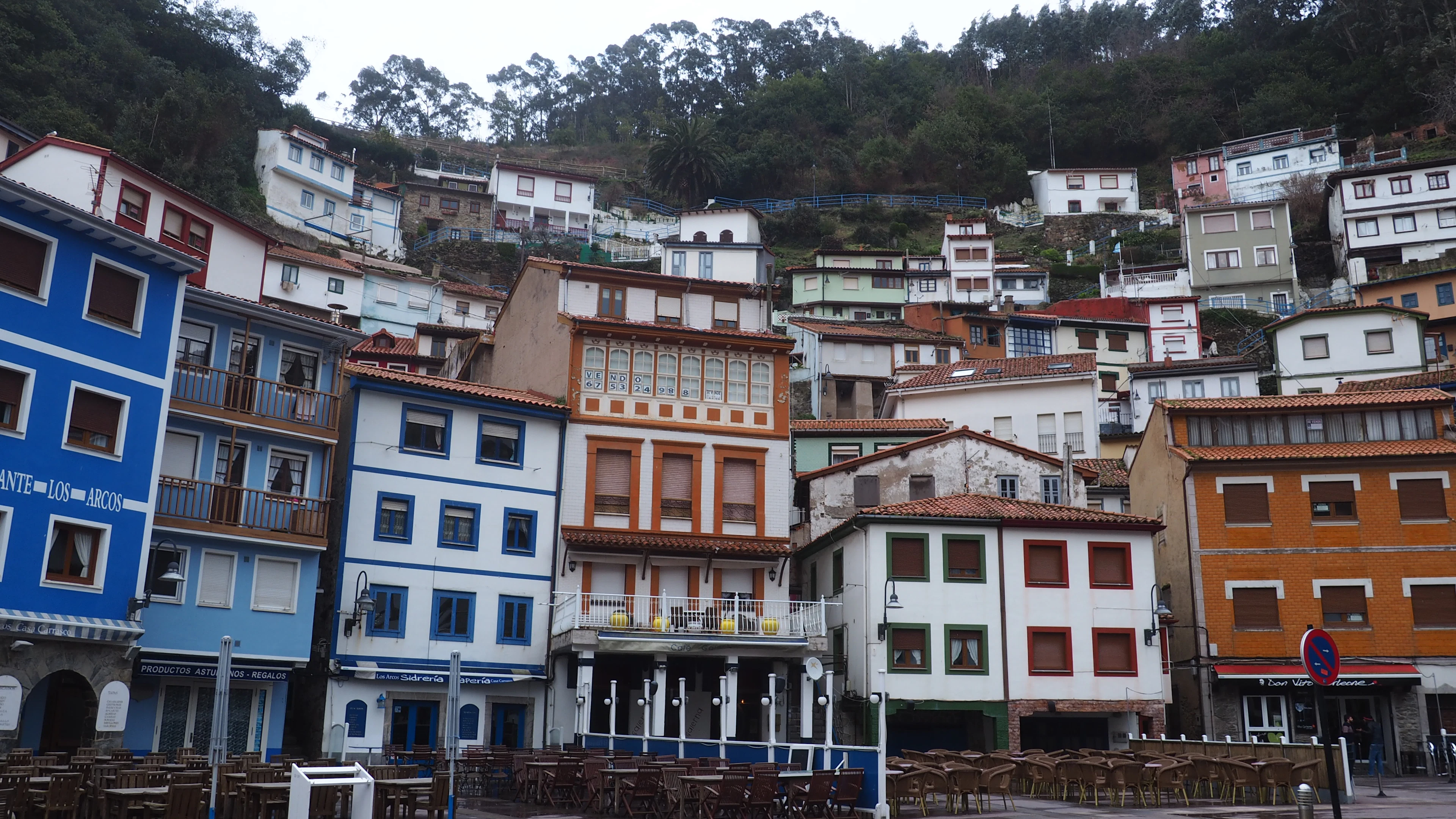 The coloured houses of Cudillero climbing the slope above the village square in Asturias