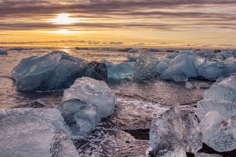 gray rock formation on the beach during sunset