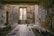 A room filled with abstract paintings covering the walls and floor. The paintings feature bold, expressive faces and colorful designs. Paints, brushes, and art supplies are scattered around. A wooden chair is positioned beside a large paper, suggesting an artist's workspace.