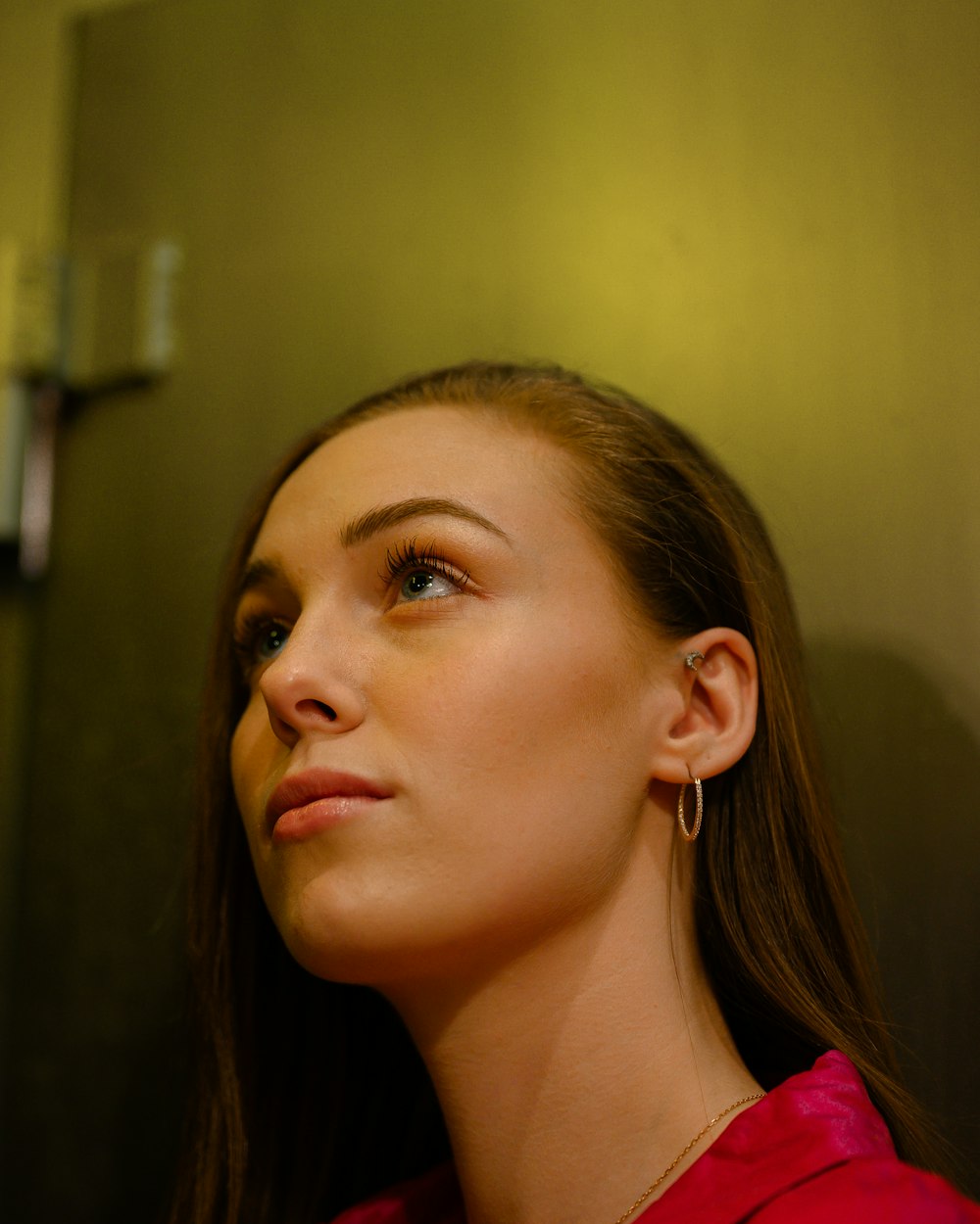 woman in red shirt looking up