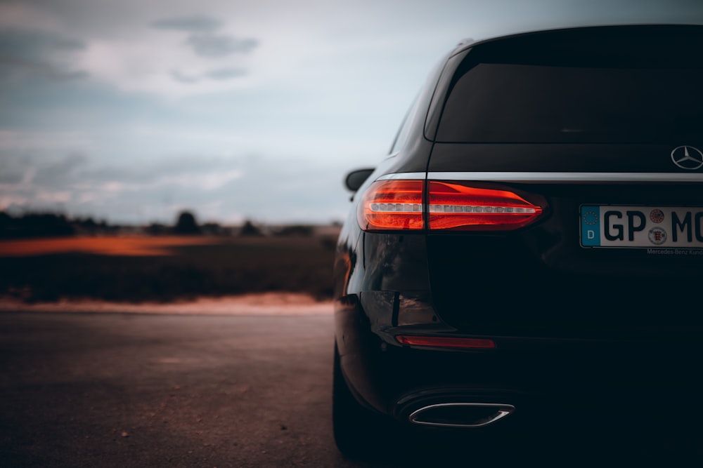 black car on brown sand during daytime