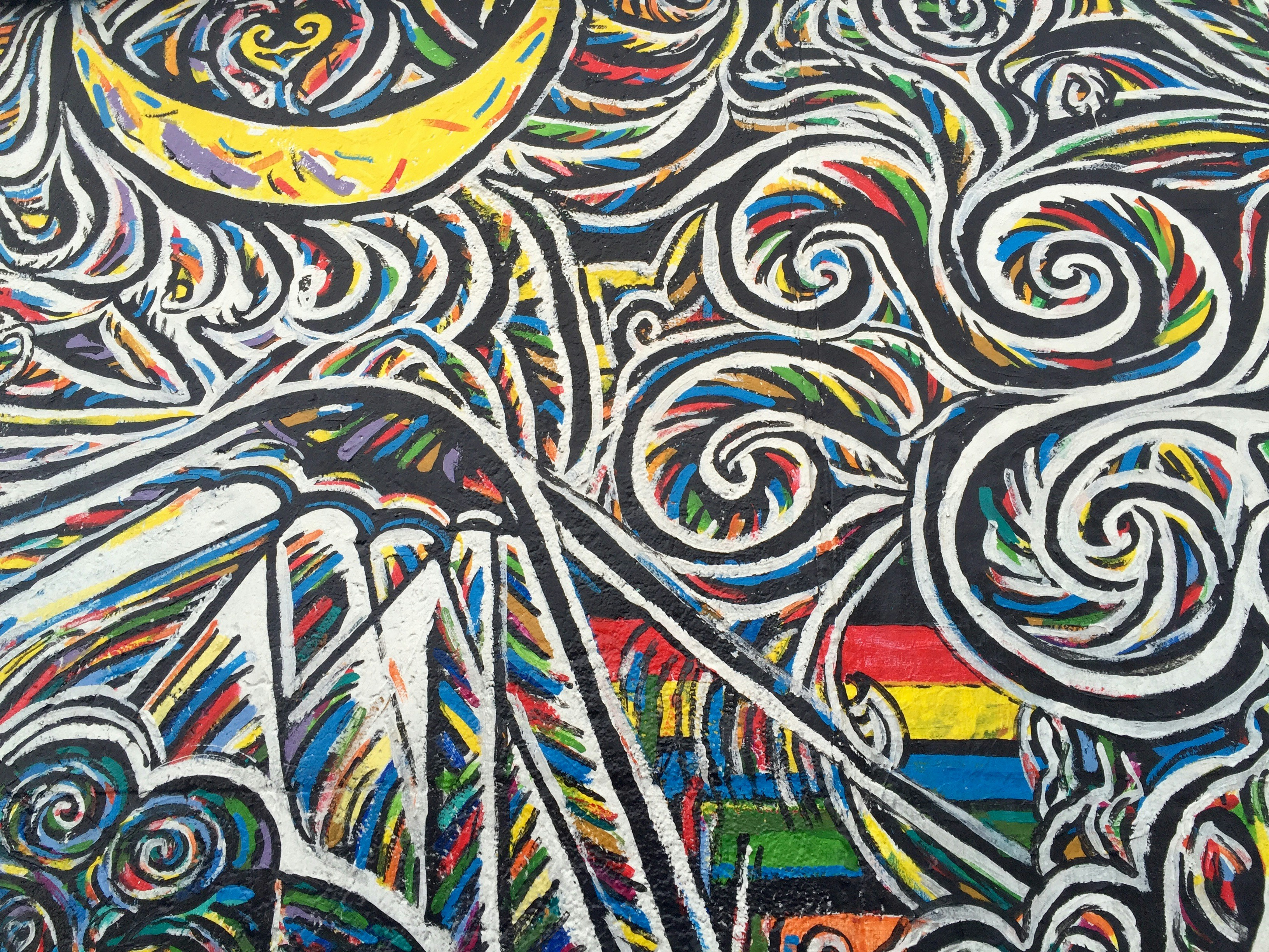 A vibrant, abstract painting depicting interfaith harmony, with elements representing different religions (like a crescent moon, a lotus, a cross) blending seamlessly into one another, symbolizing unity and peace.