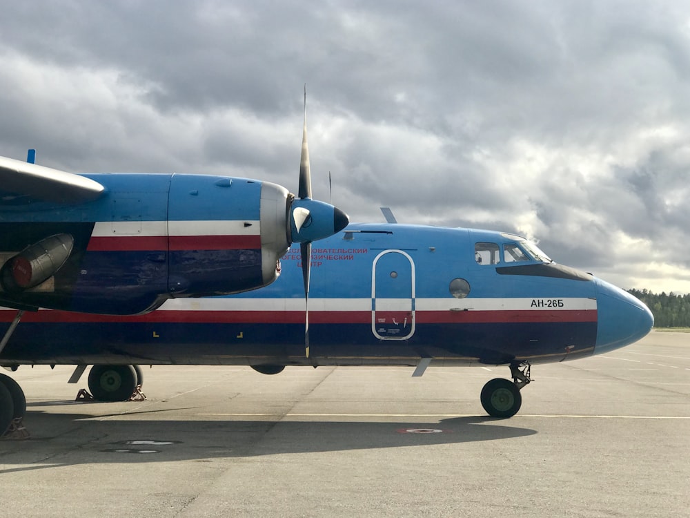 blue and red passenger plane on airport during daytime