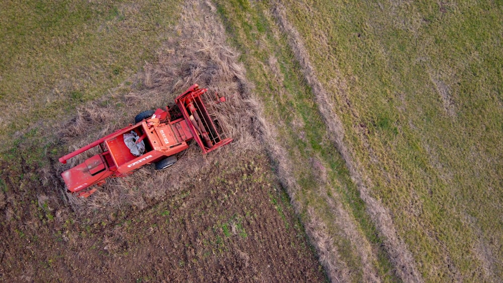 red and black utility trailer on green grass field