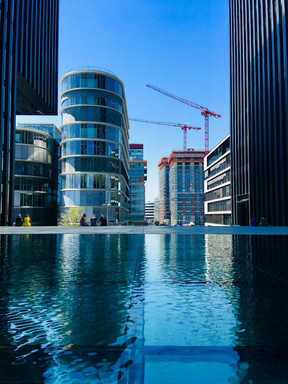 body of water near high rise buildings during daytime