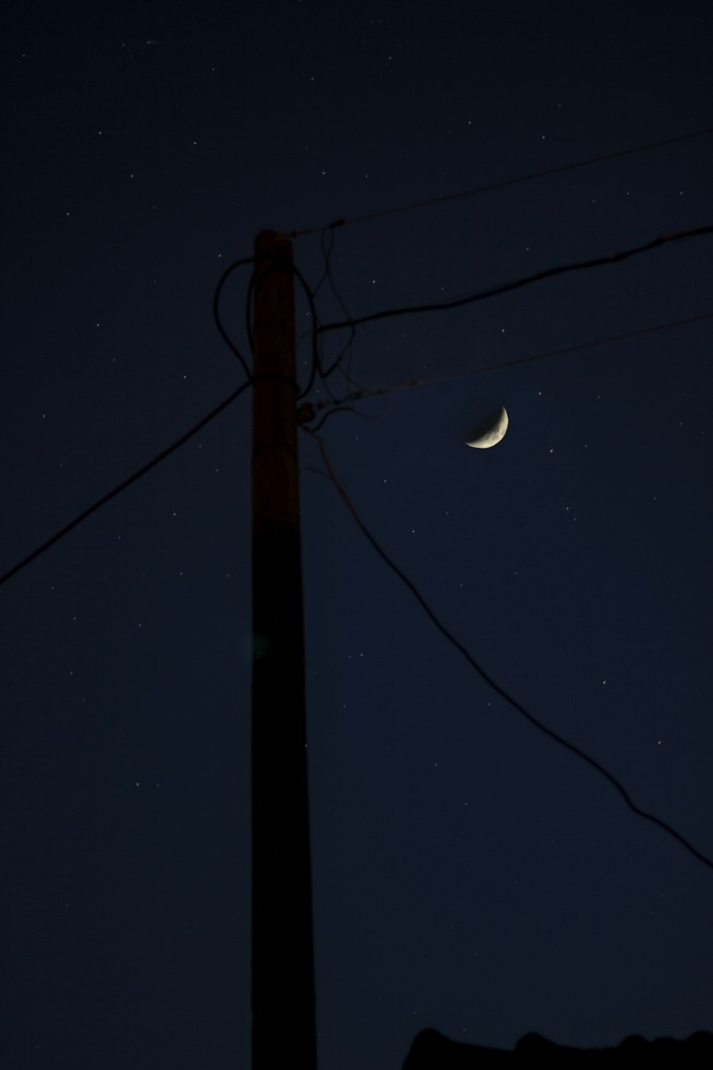 crescent moon over black sky during night time