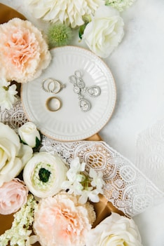 white and pink roses on white ceramic round plate