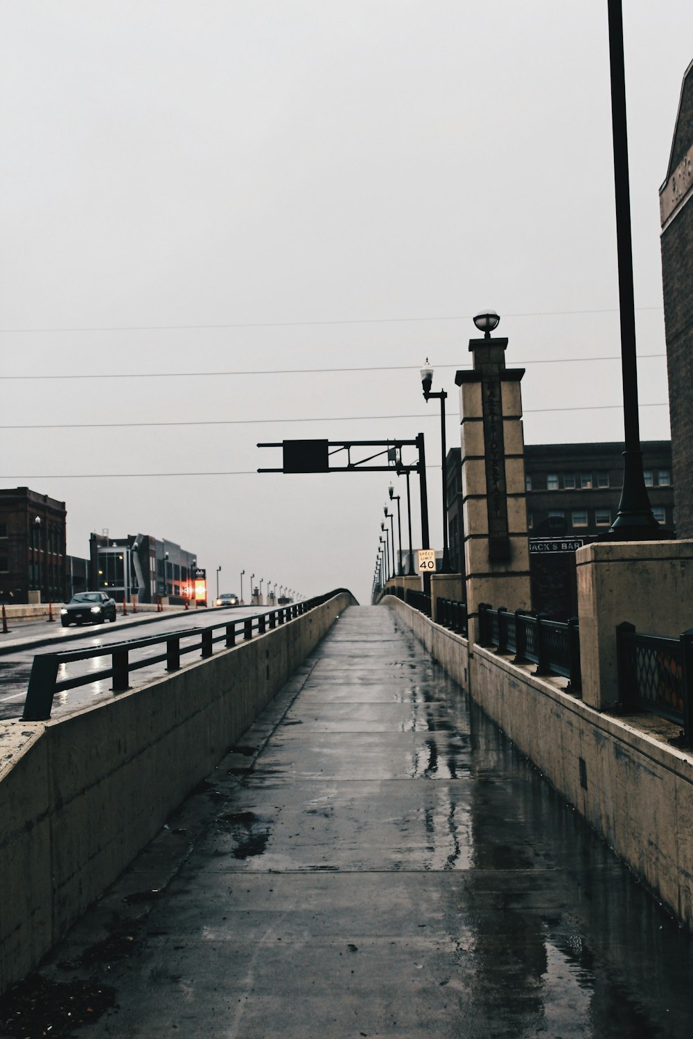 gray concrete bridge near city buildings during daytime
