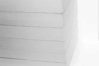 Close-up of white nylon PA6 sheets stacked neatly in a workshop