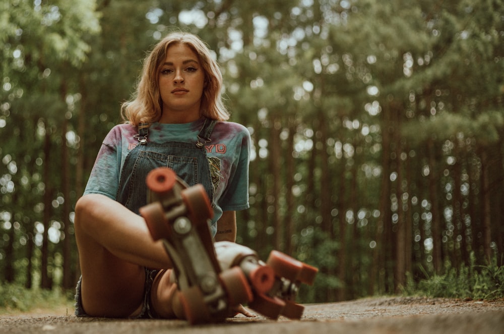 girl in green dress holding red toy gun