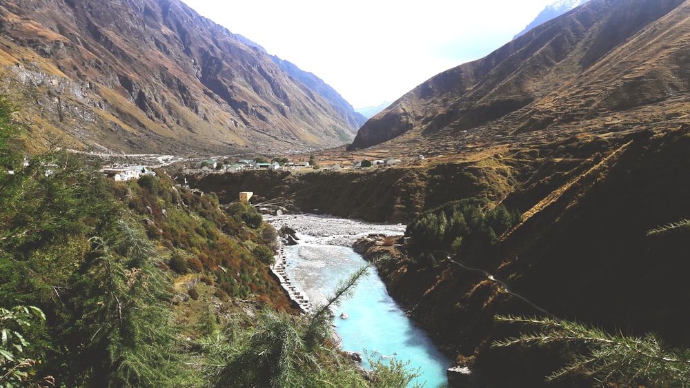 river between mountains during daytime