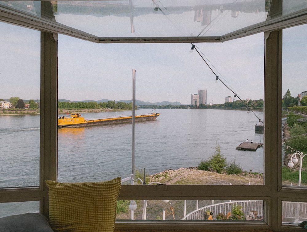 brown wooden armchair beside body of water during daytime