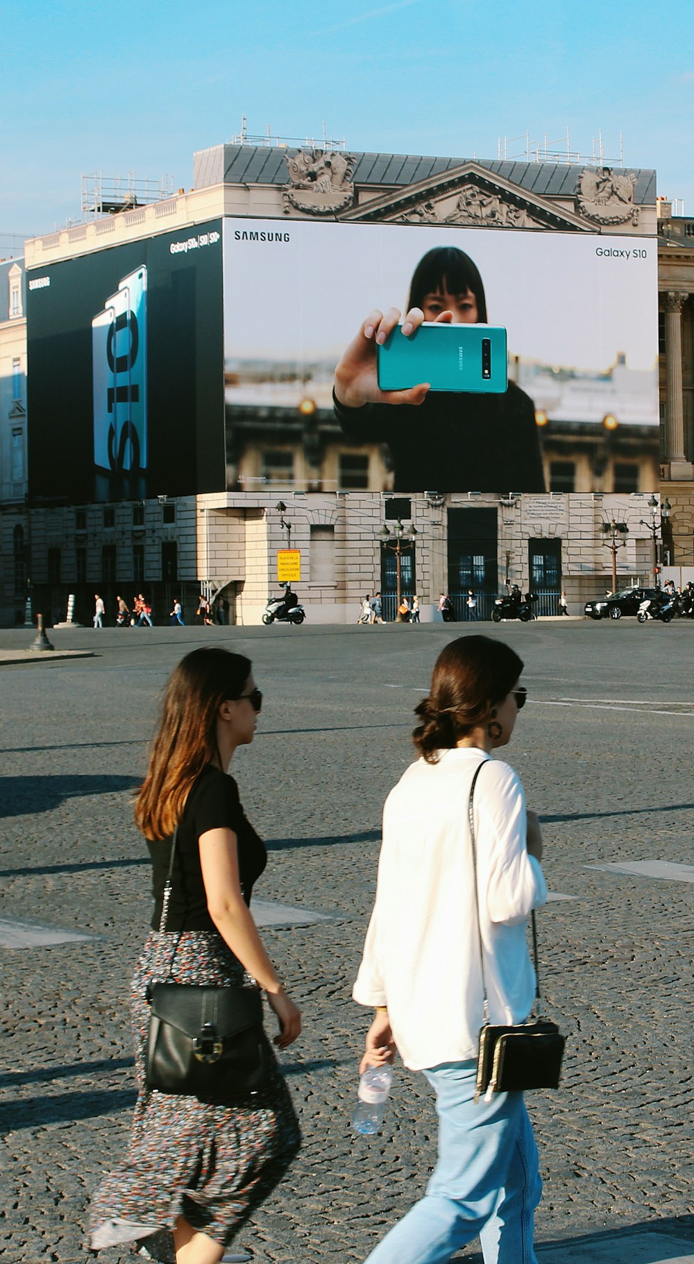 woman in white shirt holding blue tablet computer