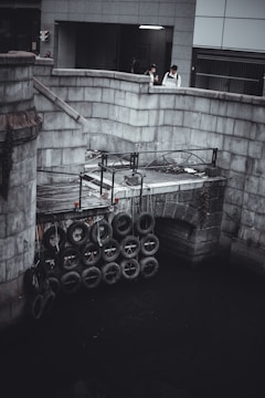 Group of students testing a bridge model for strength.