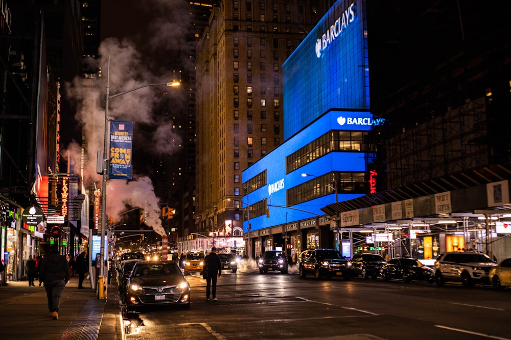 cars on road near buildings during night time