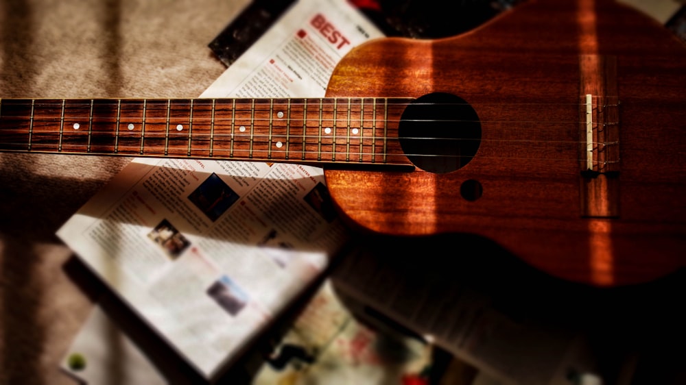 brown acoustic guitar on brown carpet