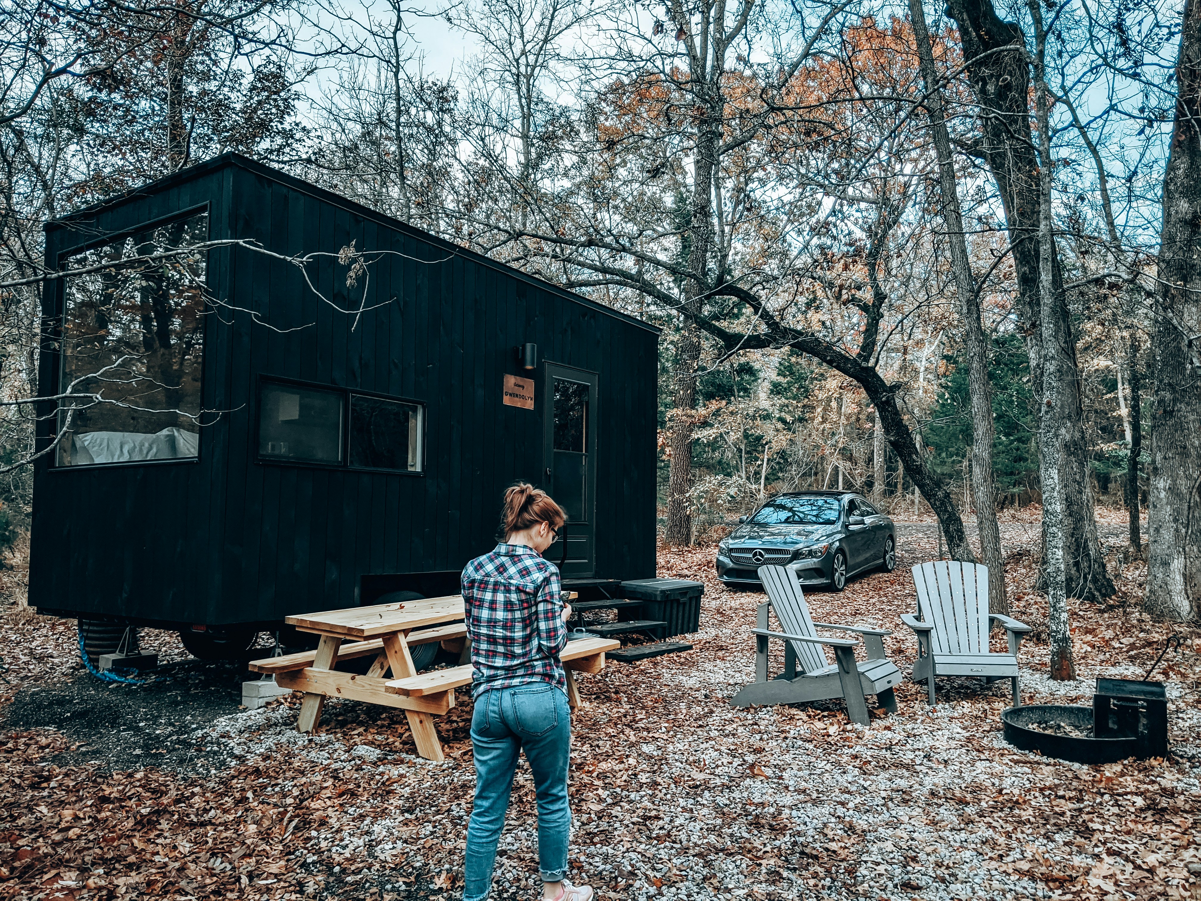 man in blue and white plaid dress shirt standing near brown wooden house during daytime, The perfect #geataway for me and my wife. 