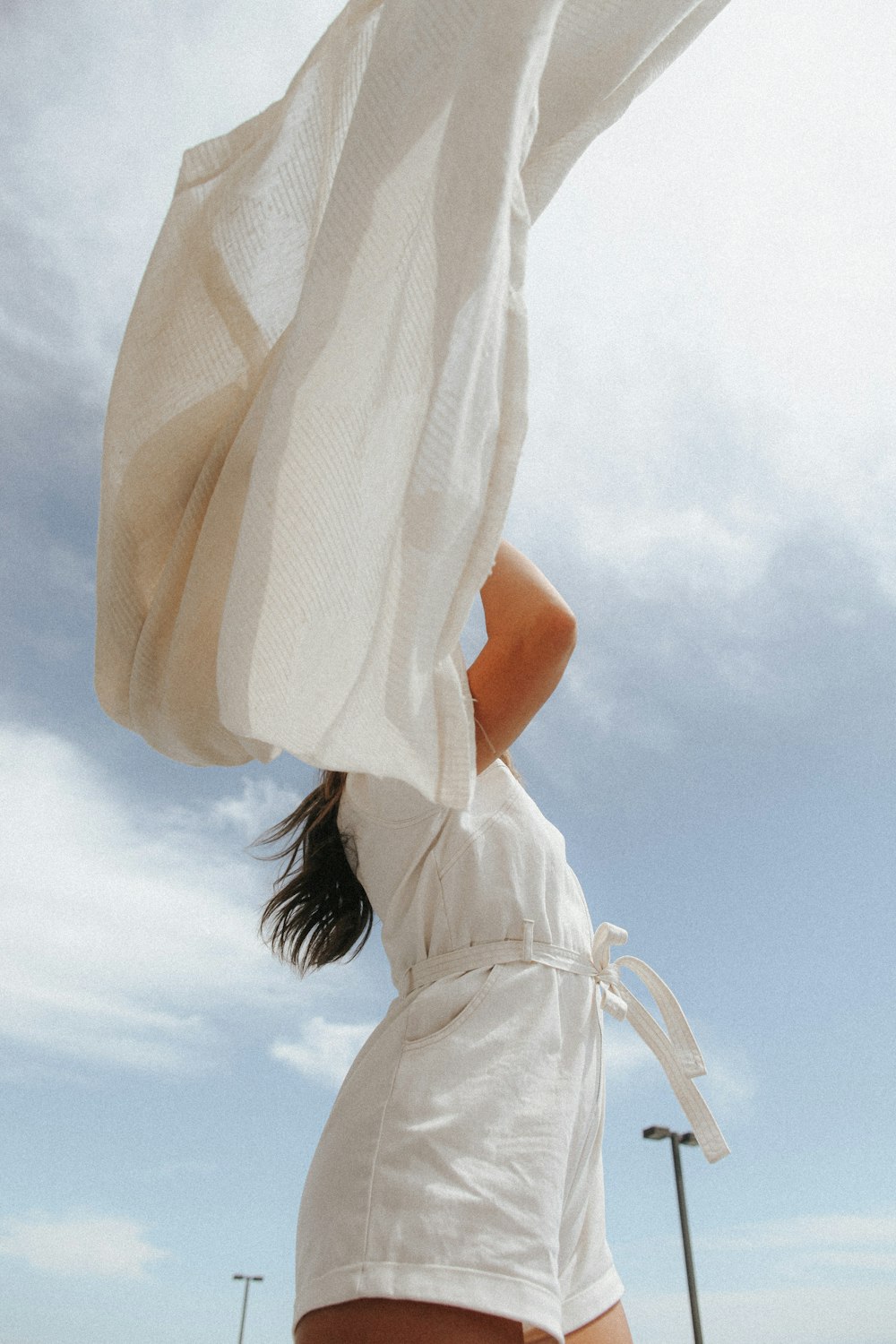 woman in white dress under blue sky during daytime