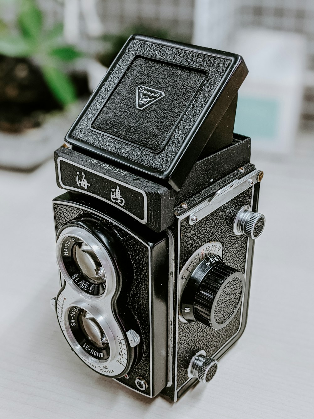 black and silver camera on white table