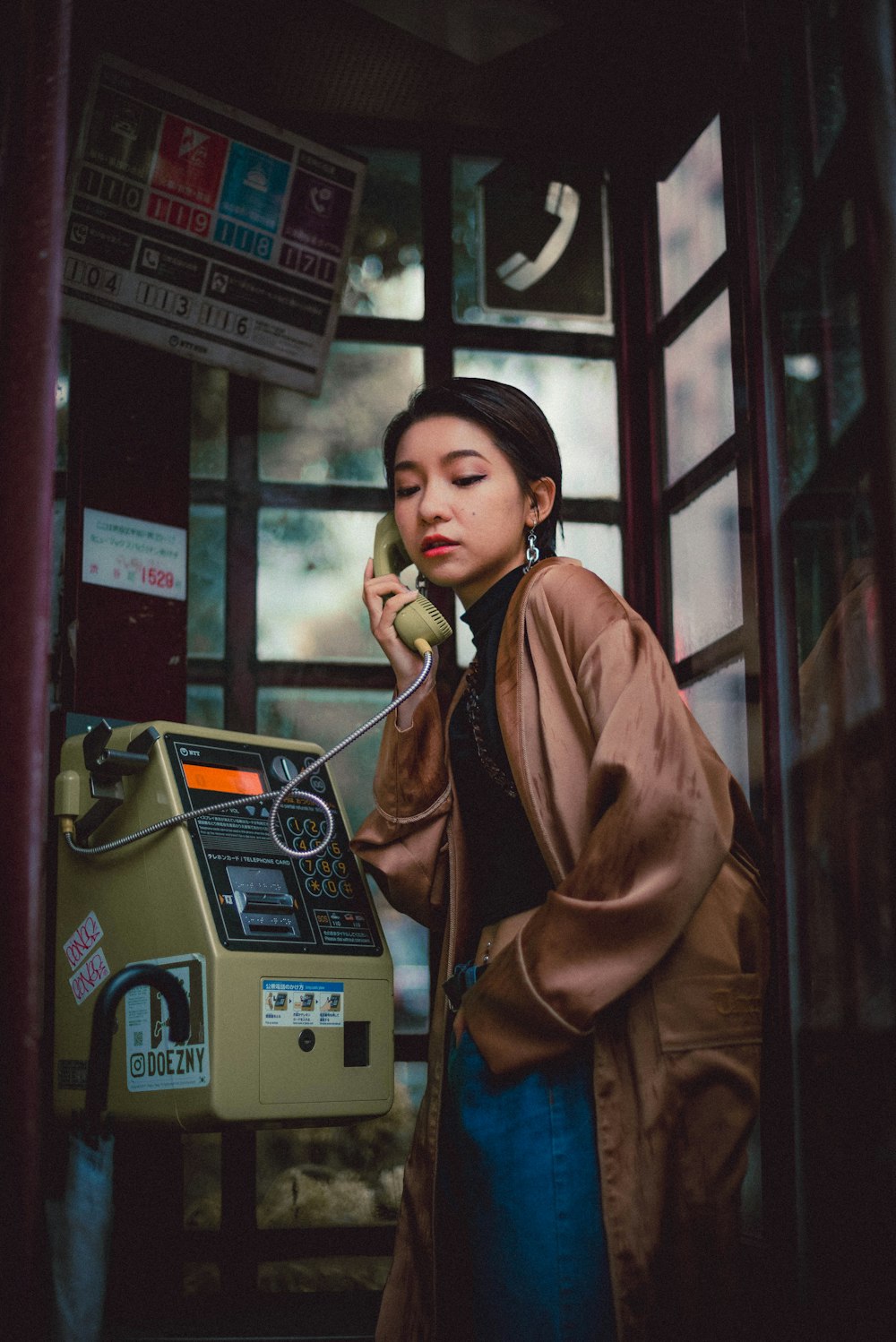 woman in brown coat standing near brown wooden door