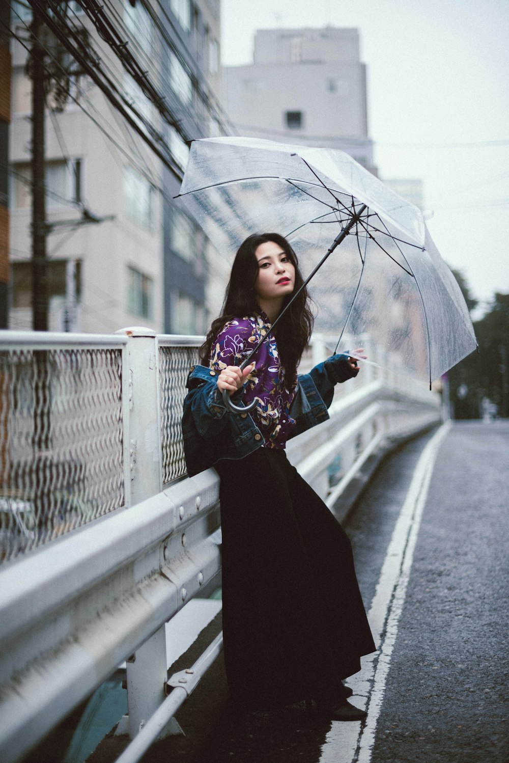 woman in black dress holding umbrella