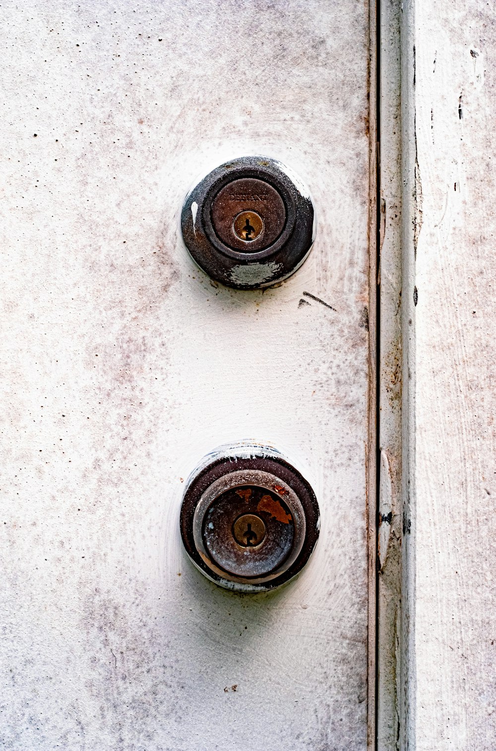 brown round metal on white wooden door