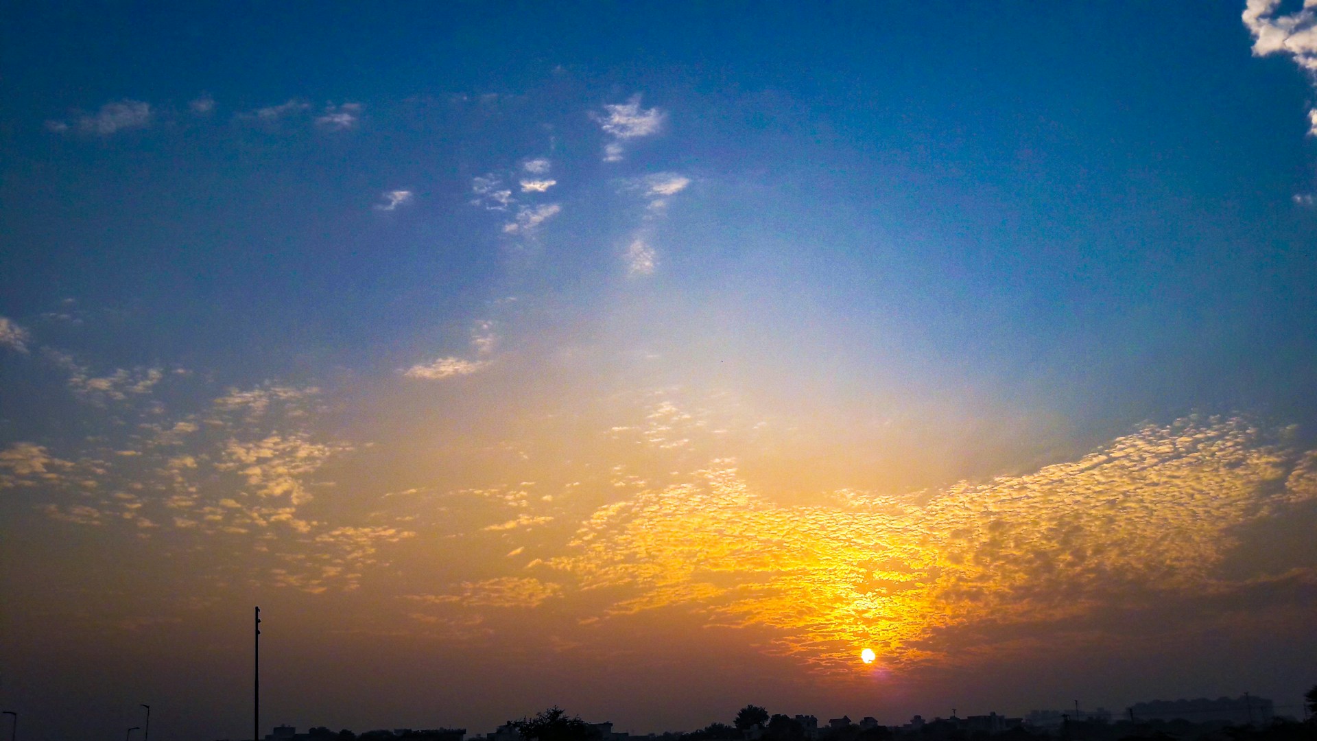 woman wearing yellow long-sleeved dress under white clouds and blue sky during daytime