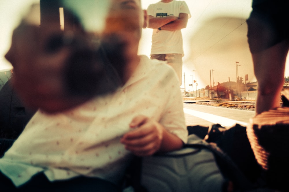 man in black jacket sitting beside woman in white and pink floral shirt