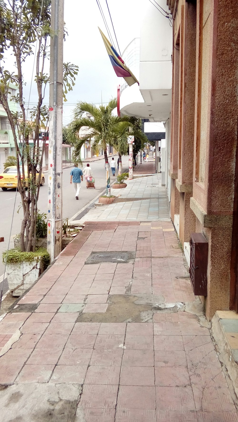 people walking on sidewalk during daytime