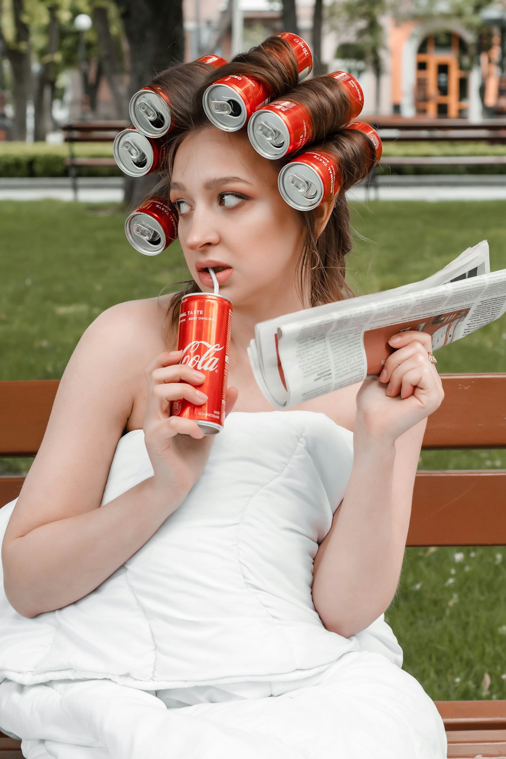 woman in white tank top holding red can