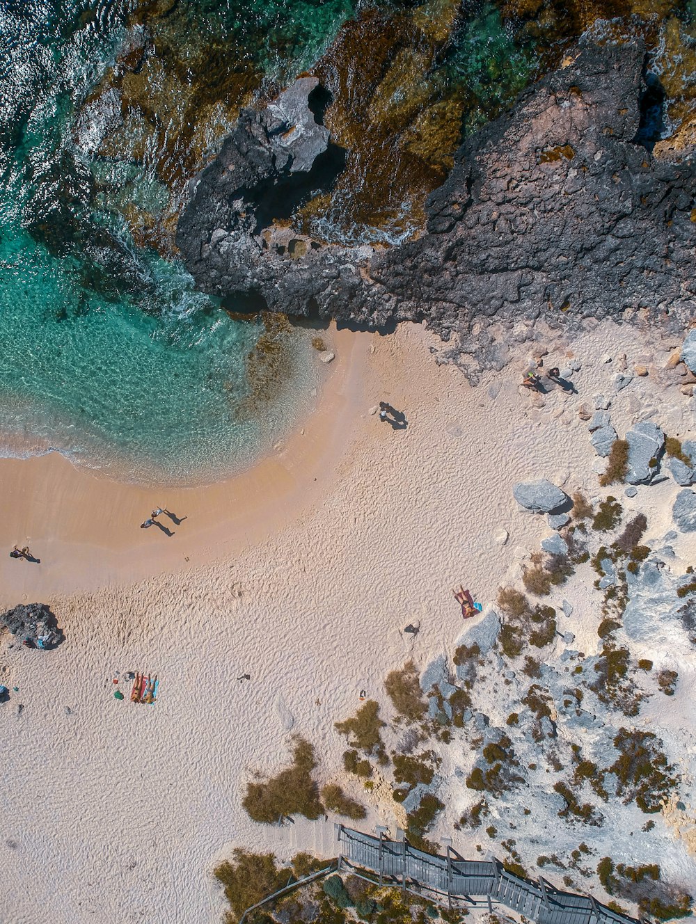 an aerial view of a sandy beach and ocean