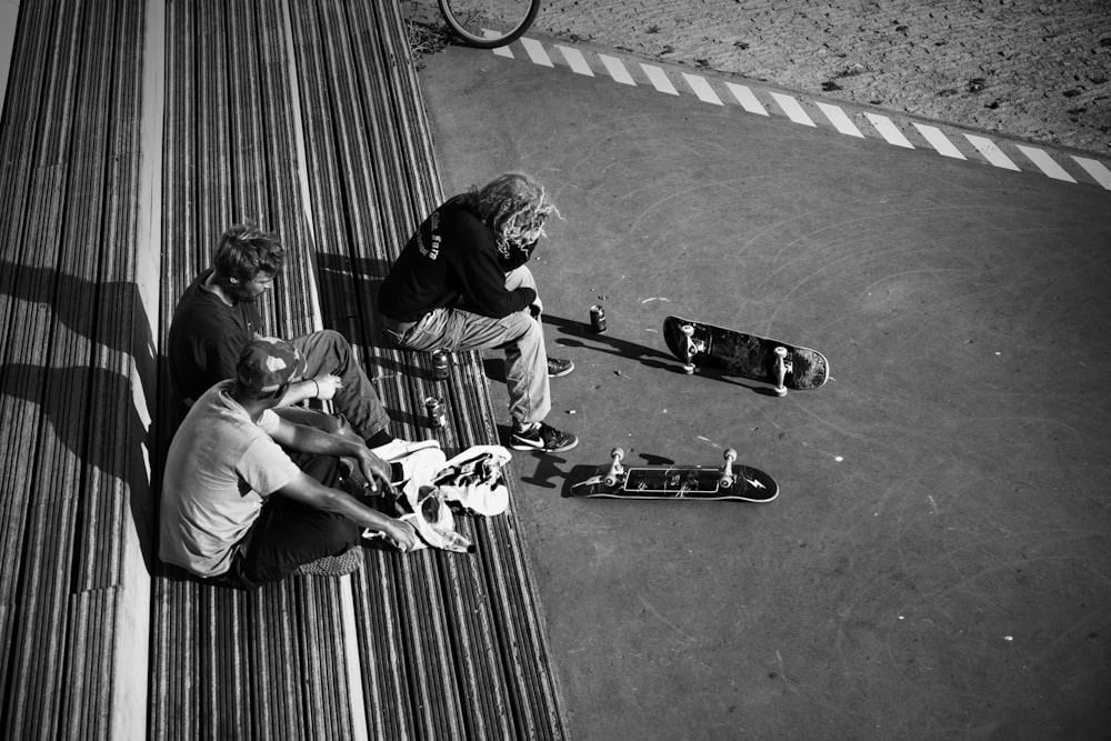 man in black jacket and pants riding skateboard in grayscale photography