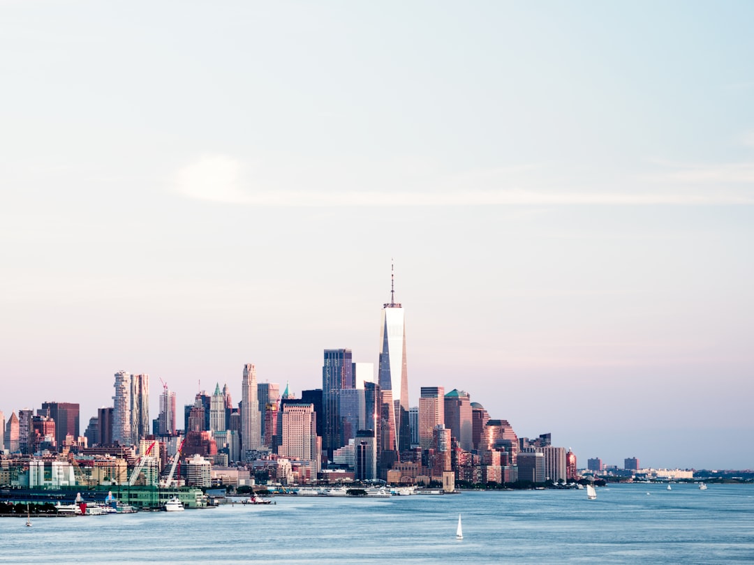 city skyline across body of water during daytime