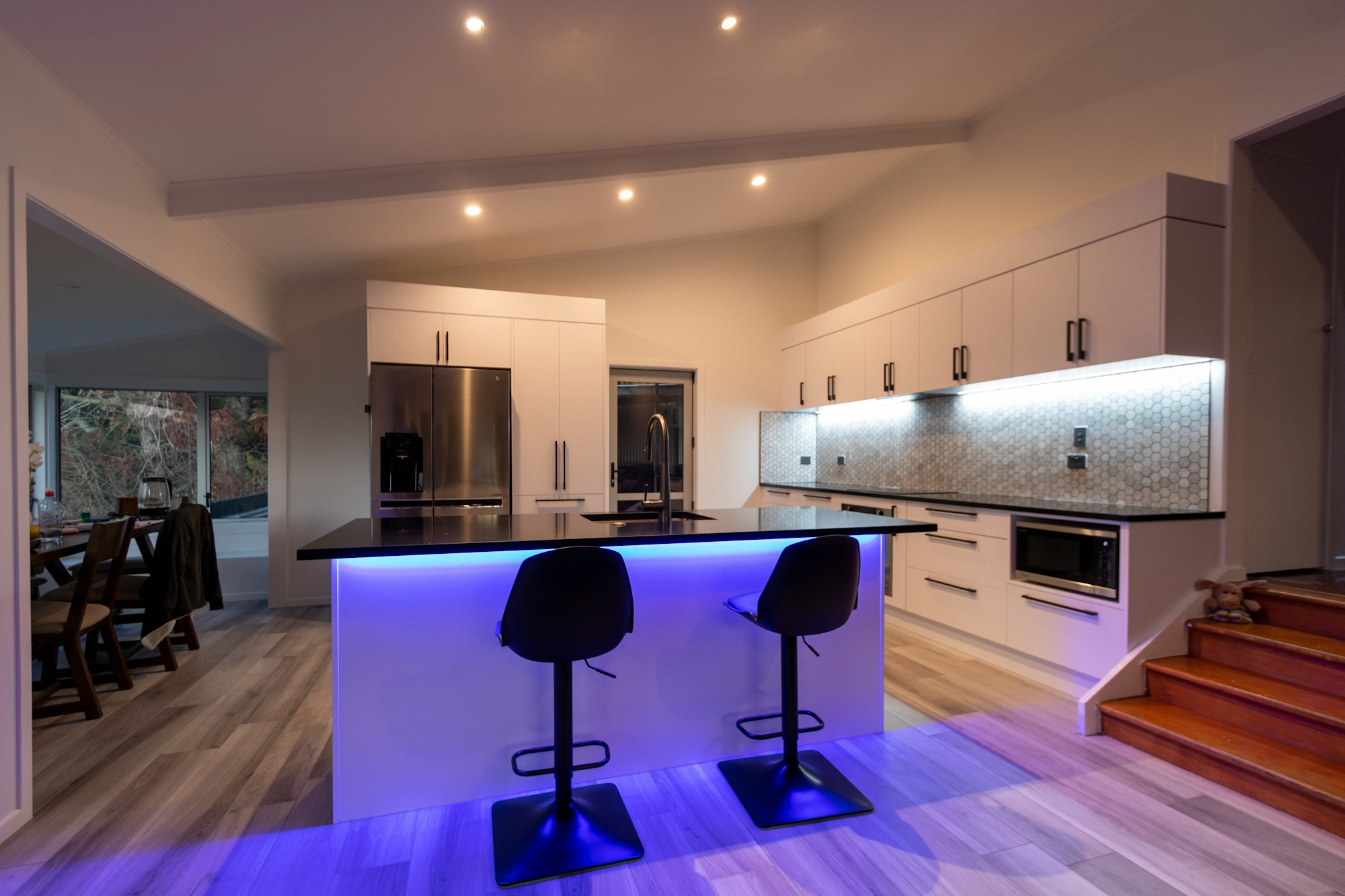 A modern white kitchen with led strip lighting
