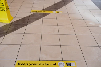 Close-up of durable floor markings and warning labels in a clean manufacturing area.