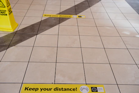 Close-up of durable floor markings and warning labels in a clean manufacturing area.