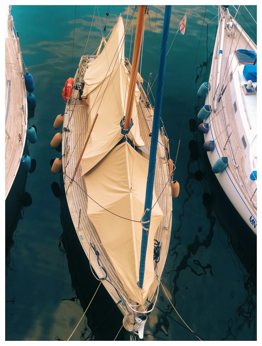 white sail boat on water