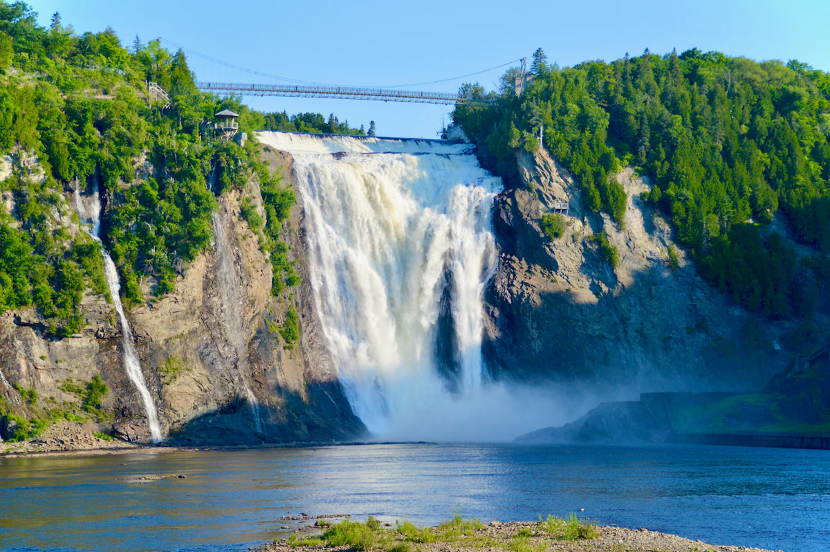 Montmorency Falls near Québec City flowing between forested cliffs