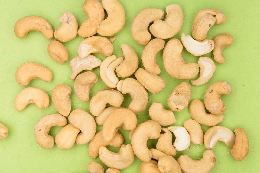 brown nuts on green plastic container