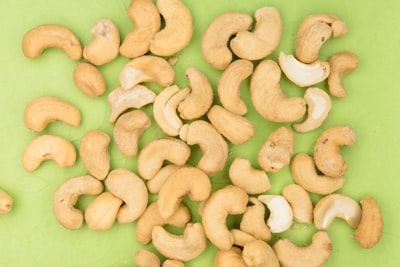 brown nuts on green plastic container tasty zoom background