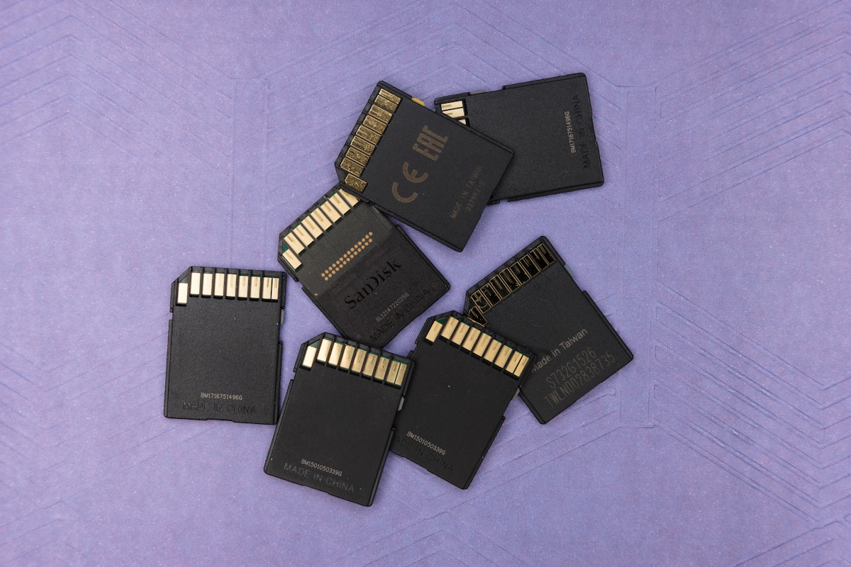 Hard drives and memory cards laid out for a documentary footage backup at the end of a shoot day