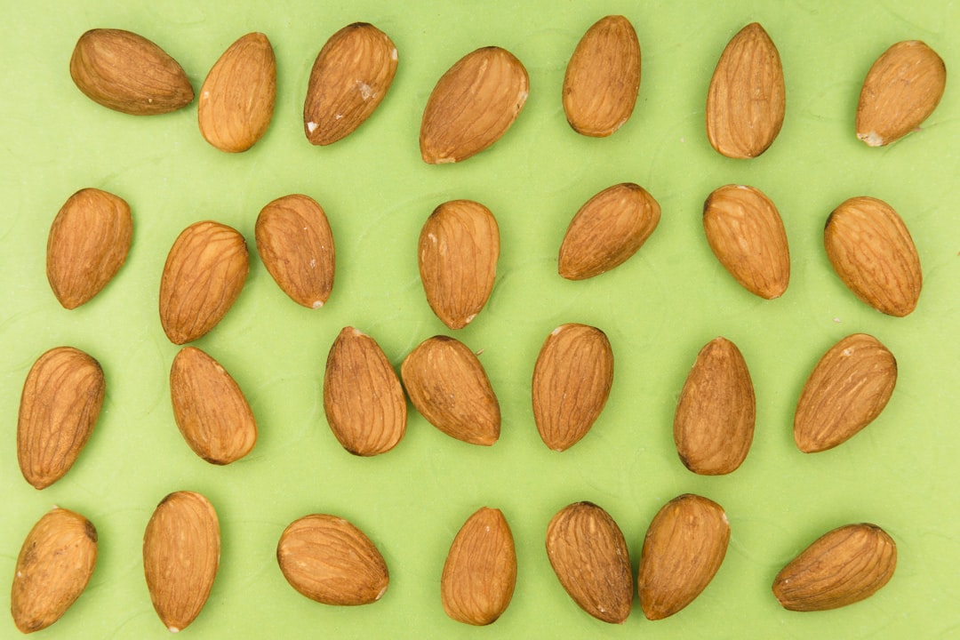 brown almond nuts on white surface