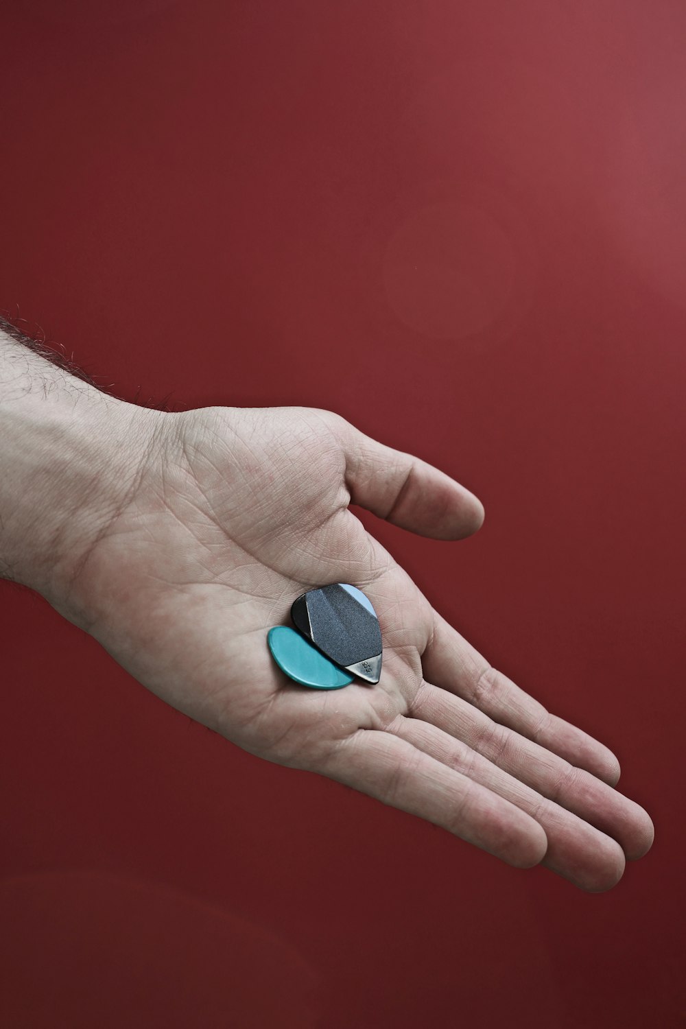 person holding blue heart ornament