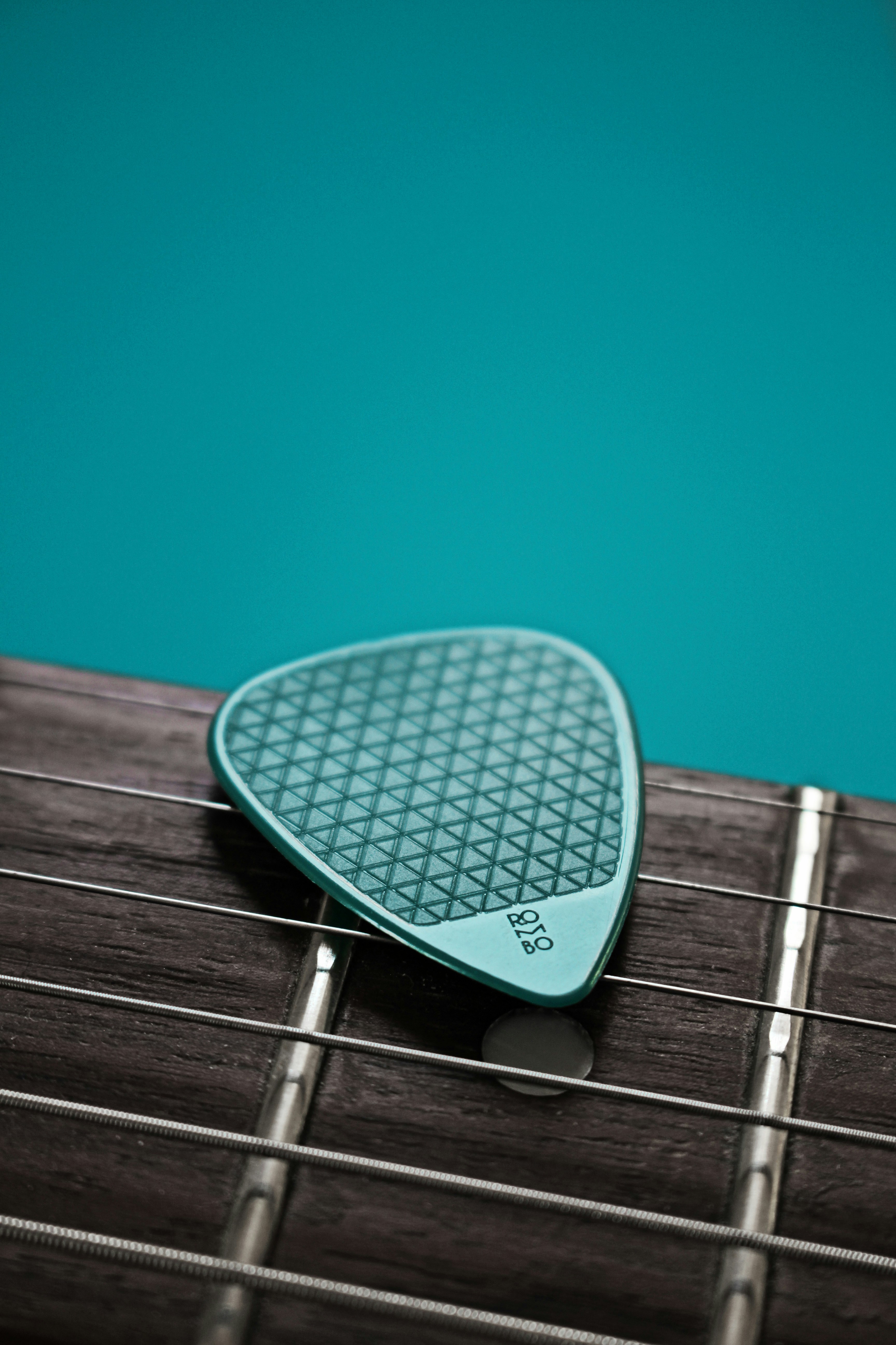 green and black guitar pick