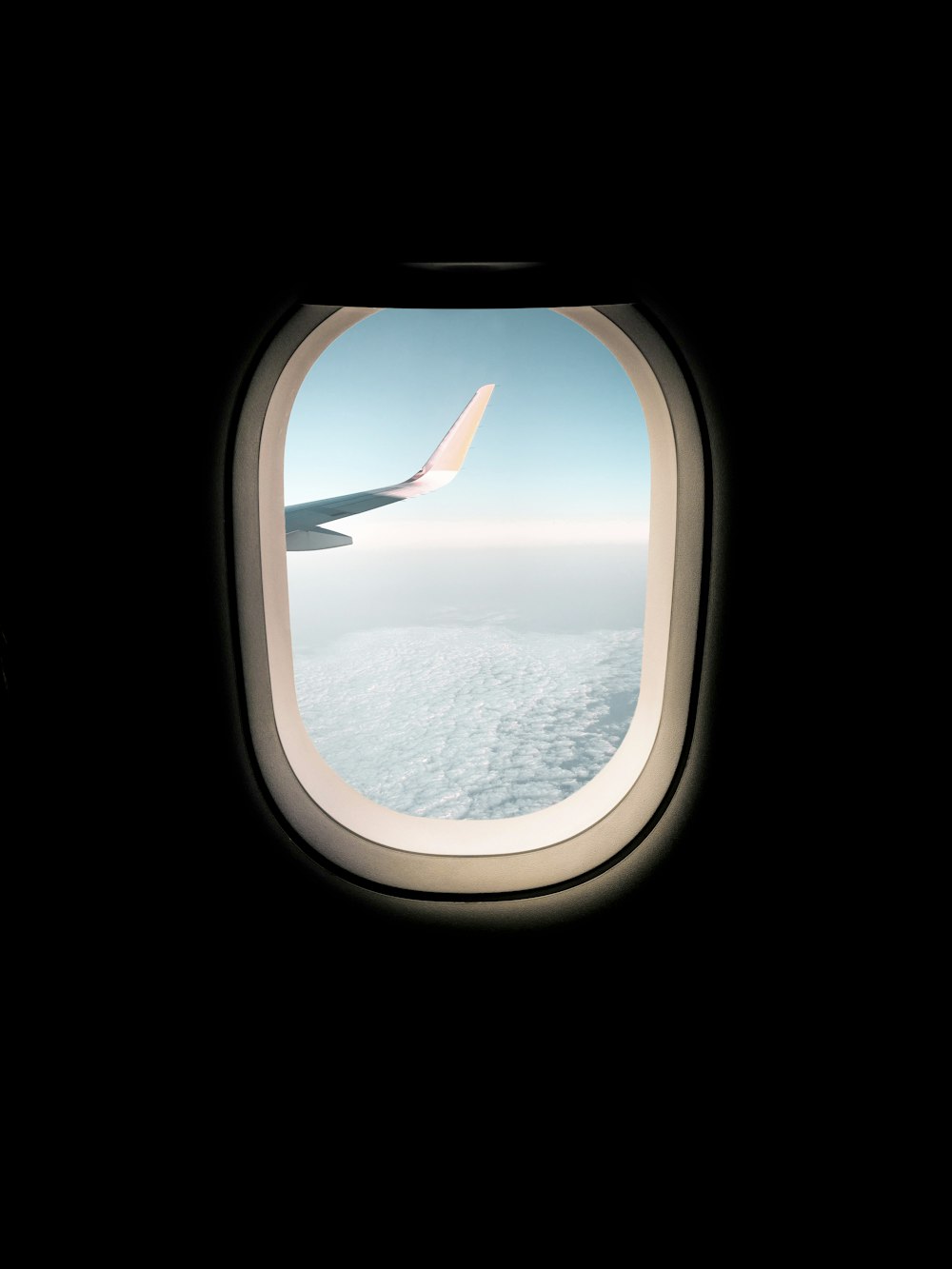 airplane window view of clouds during daytime