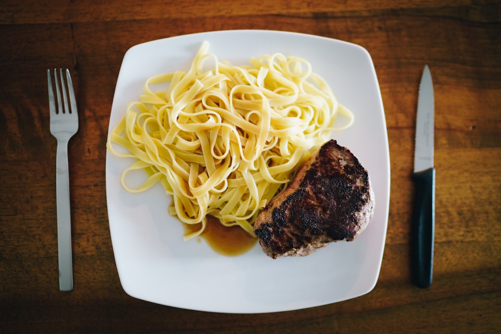 plat de pâtes sur assiette en céramique blanche