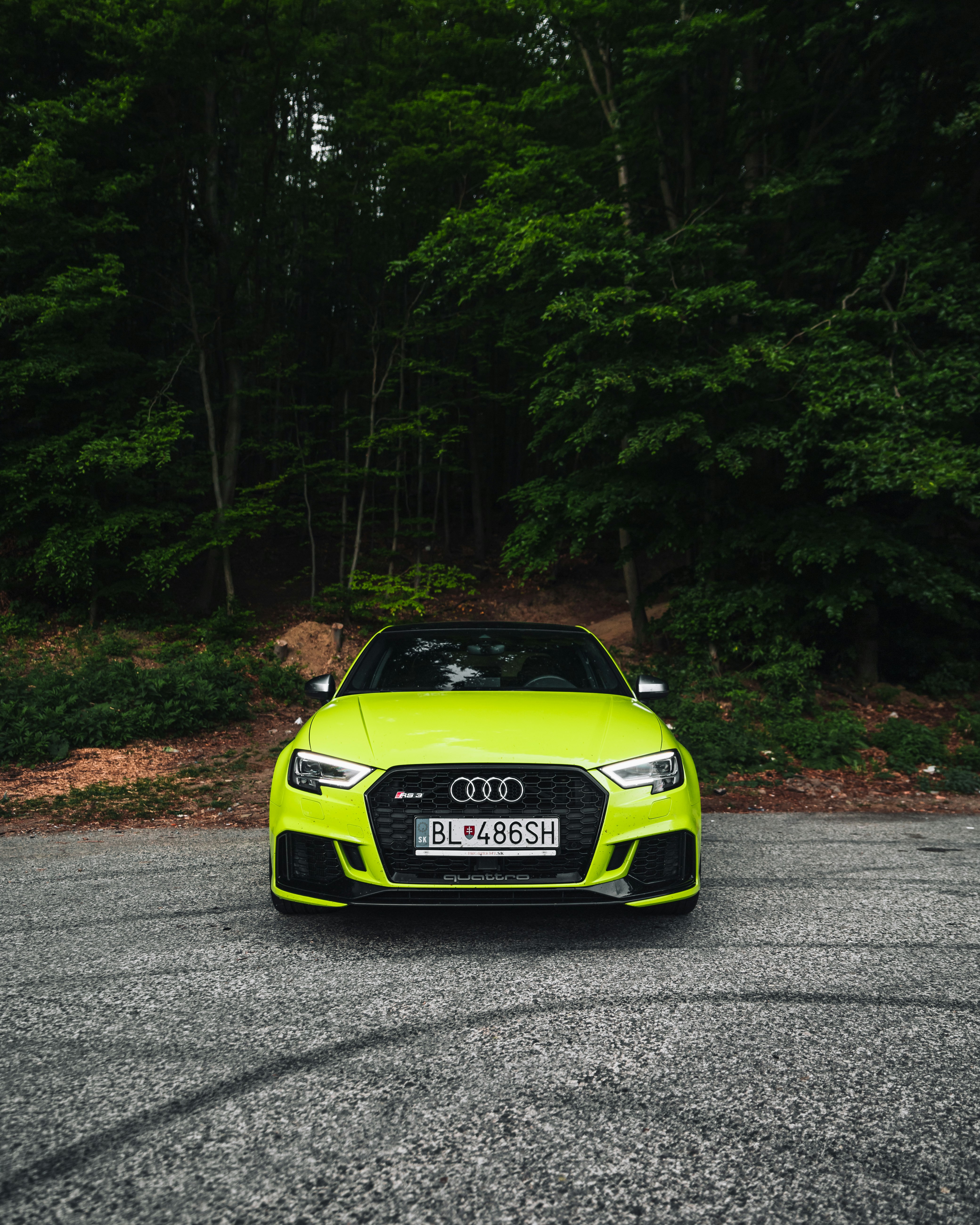 green and black porsche 911 on road