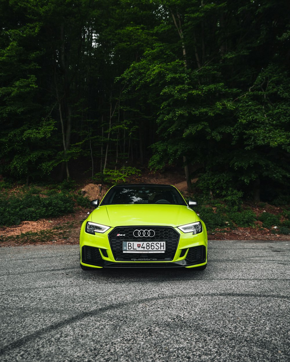 green and black porsche 911 on road